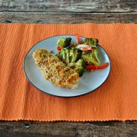 Delicious Hummus Crusted Chicken served with a side of roasted vegetables