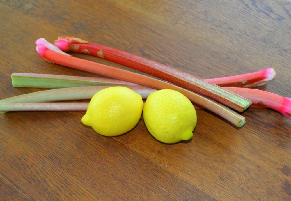 Two lemons and a stack of rhubarb stalks.