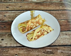 Bite of a piece of this Savory Breakfast crepe with egg, bacon, cheese, and pears for a delicious morning meal.