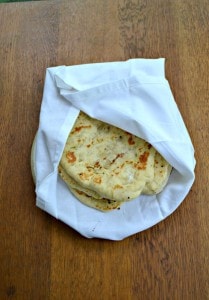 Naan is a traditional flatbread often used in Indian cooking to help scoop up the remaining food on the plate.