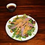 Steak and Fries on a bed of mixed greens make for a tasty Steak Salad
