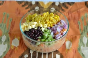 A brilliant Mexican Pasta Salad with onions, black beans, corn, cheese, and Sabra salsaonions, black beans,