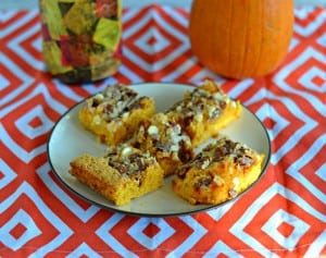These Gooey Pumpkin Cookie Bars are topped with white chocolate, cinnamon chips, pecans, and covered with milk that turns to caramel when cooked.