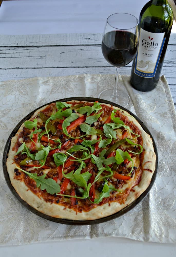 Make gourmet pizza at home with this Chorizo and Roasted Pepper Pizza with Arugula and a tasty glass of Gallo Family Vineyards Merlot