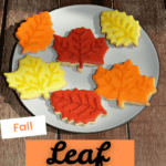 Pin Image: A plate of red, yellow, and orange leaf shaped cookies, title.