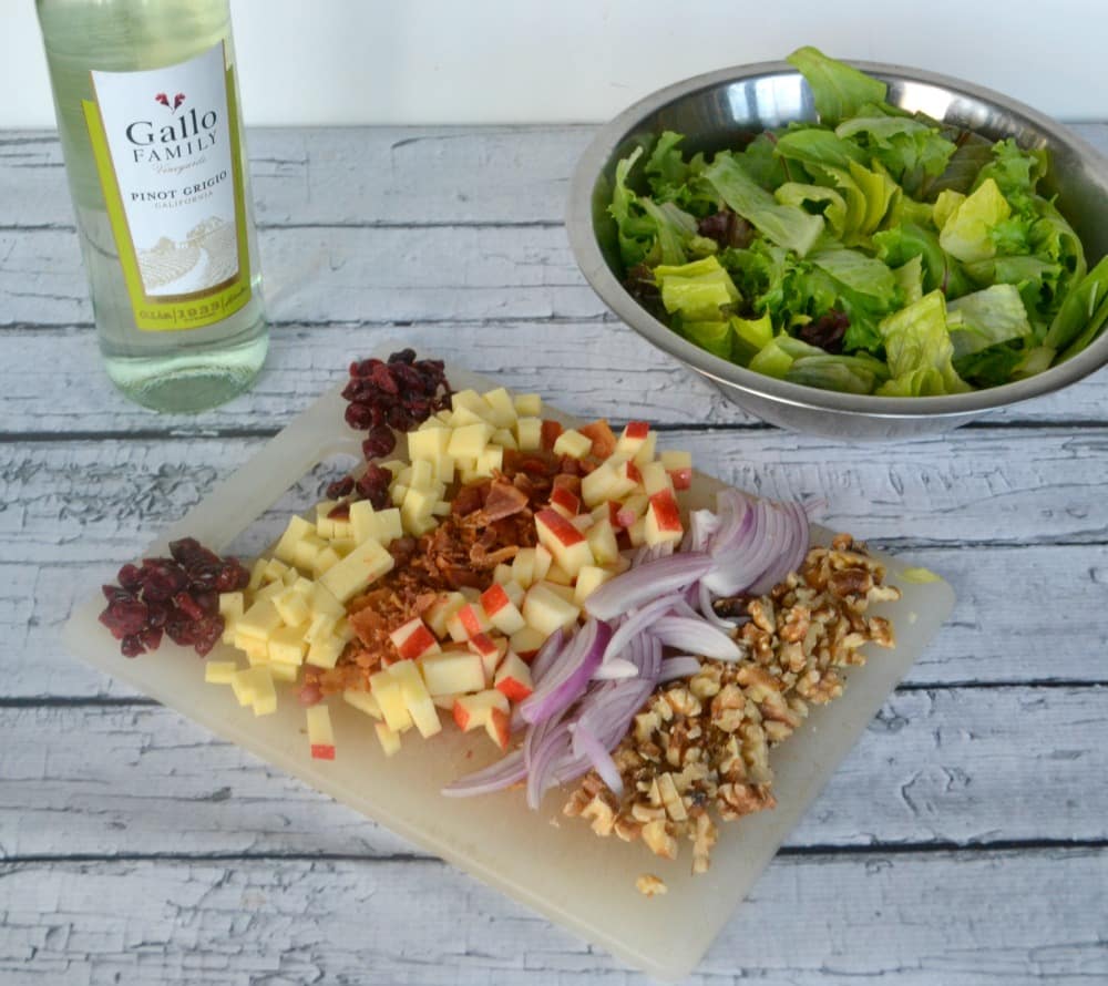 Harvest Salad is a tasty combination of lettuce topped with red onions, cheese, walnuts, and cranberries with a homemade vinaigrette.
