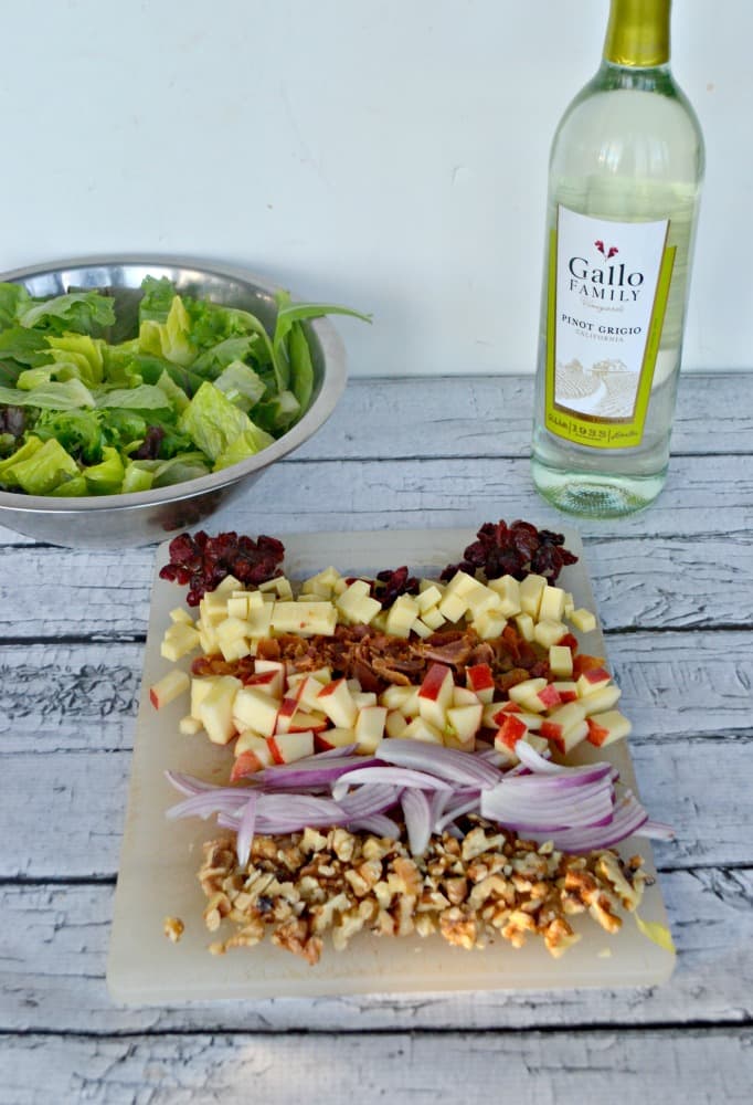 Delicious Harvest Salad topped with red onions, cranberries, apples, and bacon with a balsamic vinaigrette