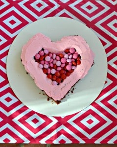 FIlled a Chocolate Cake with pink frosting and M&M's® Strawberry for a Valentine's Day surprise treat!