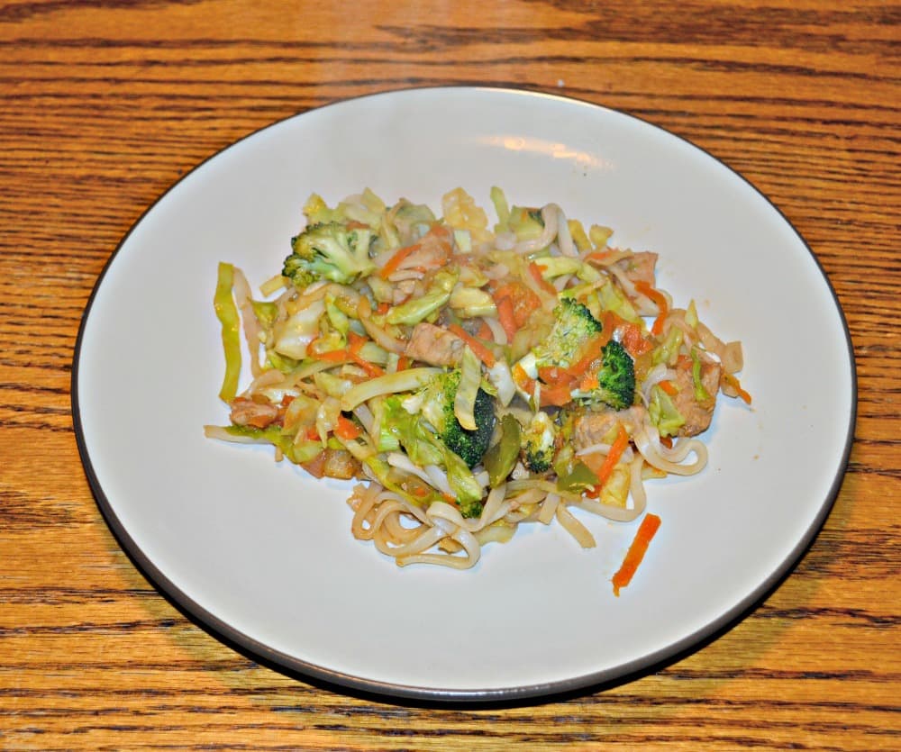 Pork and vegetable stir fry over noodles