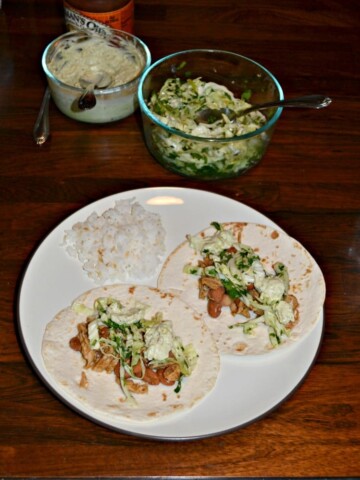Take a bit of these incredible Pork and Pinto Bean Tacos with jalapeno Slaw on top!