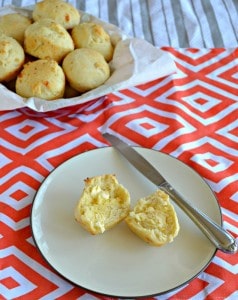 Grab a warm Garlic Cheddar DInner Roll and spread it with butter for a delicious roll.