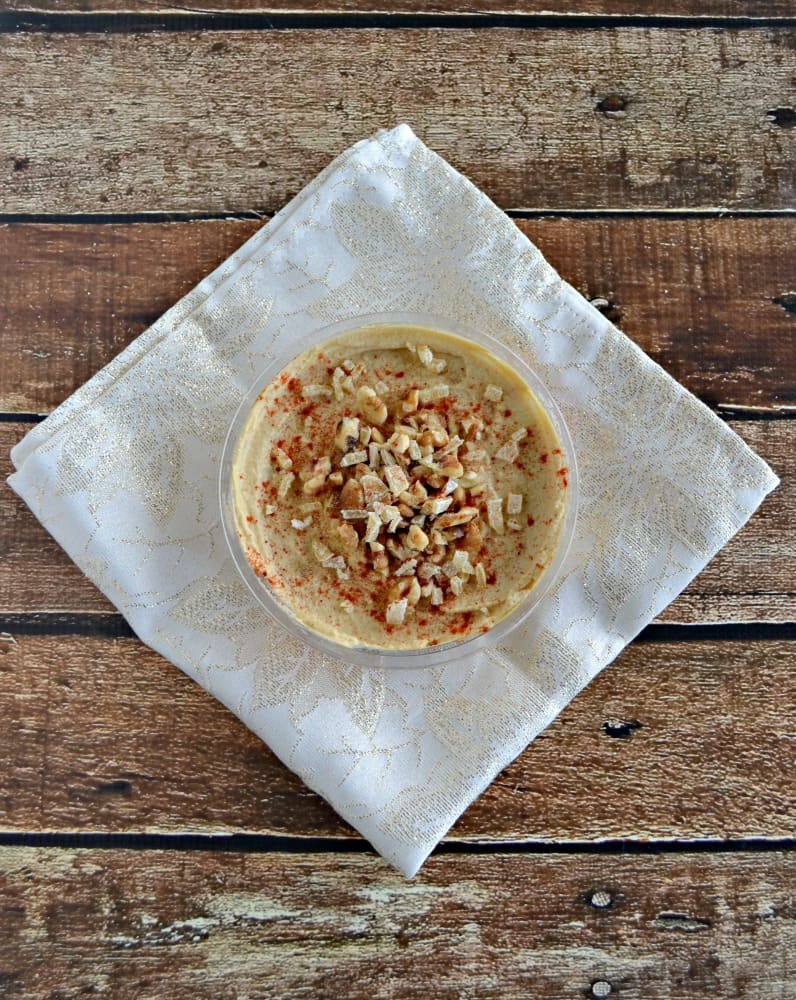 Sabra Original Hummus topped with Walnuts and Ginger is a delicious snack before dinner.