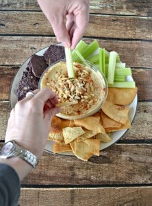 Make your hummus something special by topping it with ginger and walnuts and served with chips and veggies