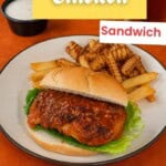 Pin Image: Title, A plate with a buffalo chicken sandwich and french fries with a cup of blue cheese behind the plate.