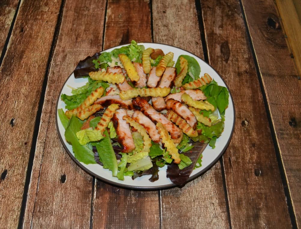 Grab a fork and dig in to this delicious BBQ Pork Salad with Fries!