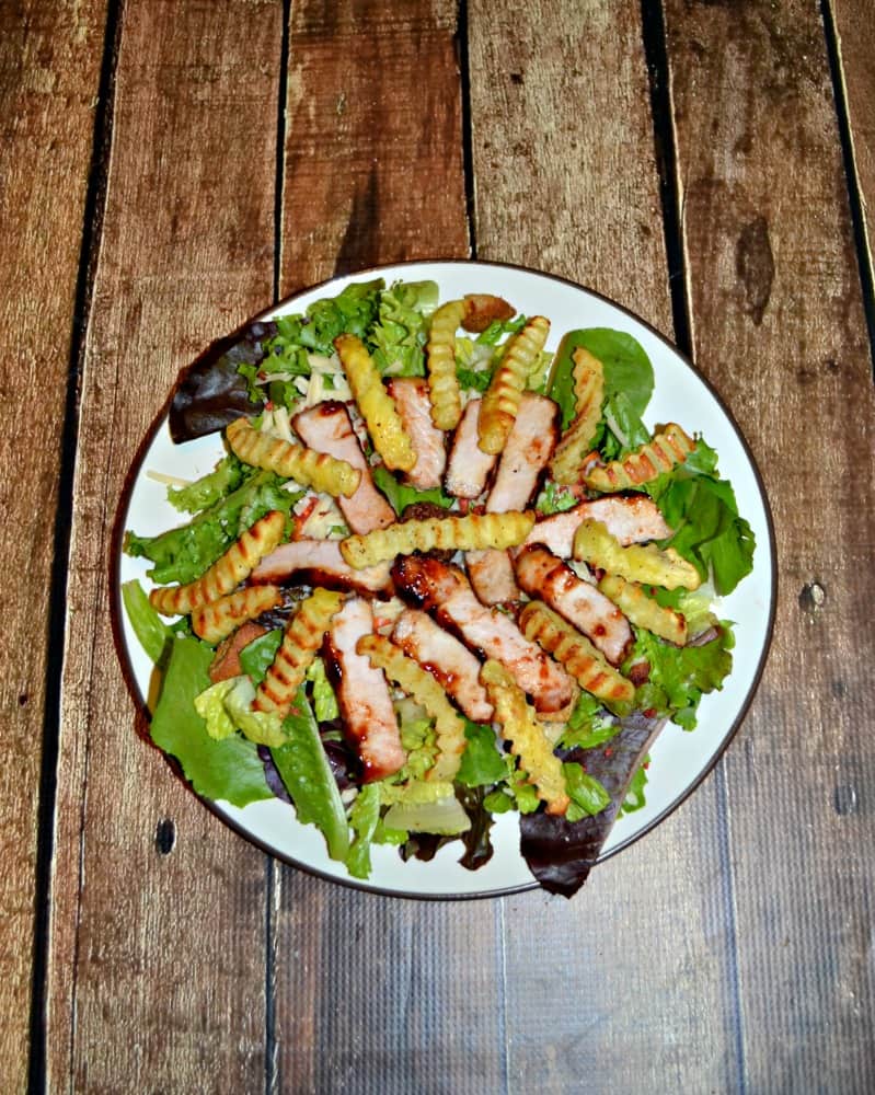 Nothing says summer like a Grilled BBQ Pork Salad topped with grilled fries!