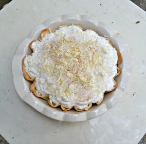 Love this Coconut Cream Pie with fresh whipped cream and topped with white chocolate and coconut