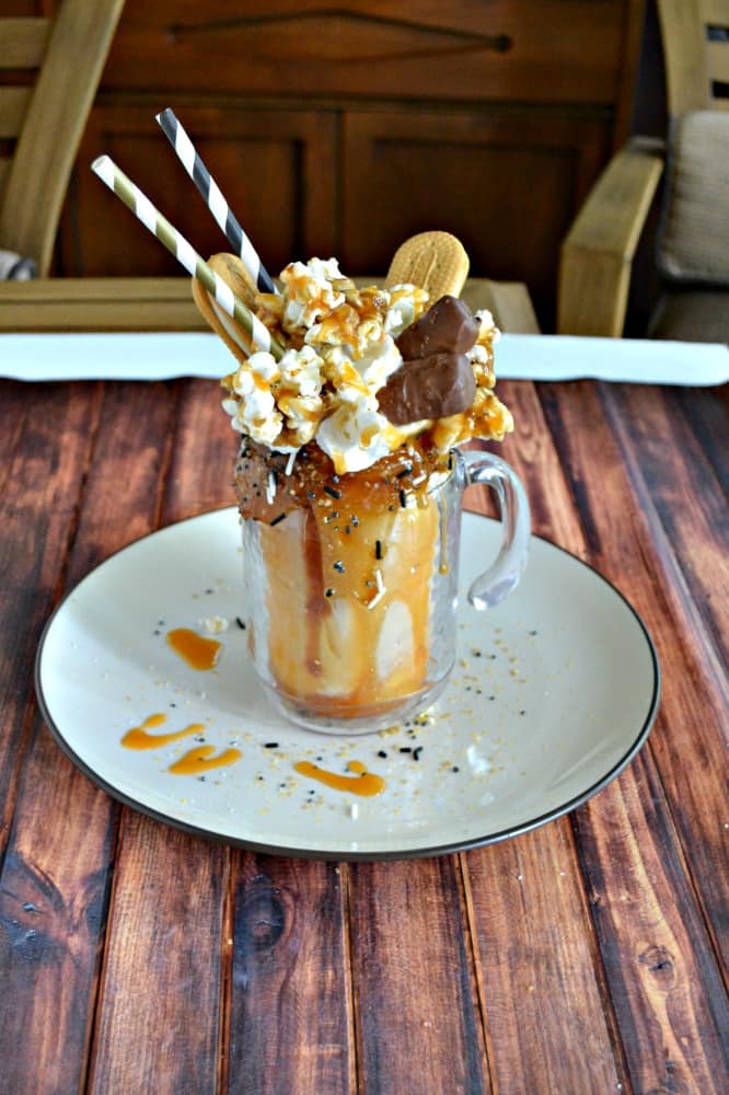 There's nothing quite like a Monster Milkshake! This delicious Caramel and Cookie milkshake topped with caramel popcorn, vanilla cookies, chocolate caramel candy, and a salted caramel drizzle!