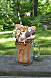 Share an over the top monster milkshake with your best friend! This Salted Caramel Cookie Monster Milkshake is filled with caramel, cookies, candy bars, caramel popcorn, and salted caramel!