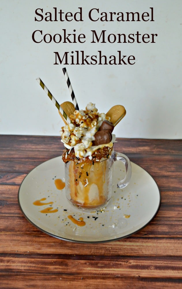 It's easy to make this Salted Caramel Cookie Monster Milkshake topped with whipped cream, vanilla cookies, caramel popcorn, candy bars, and caramel sauce!