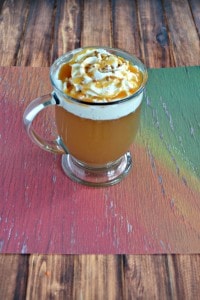 A mug of Caramel Apple Cider with whipped cream on top.