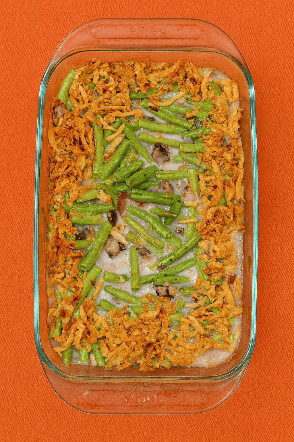 A baking dish with green bean casserole topped with fried onions on top.