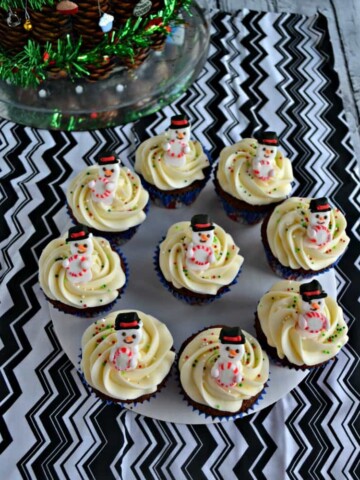 These tasty Gingerbread Cupcakes with Eggnog Frosting and mini snowmen are a delicious dessert all winter long!