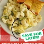 Pin Image: A close up of a plate of tortellini and vegetables with garlic bread, title.
