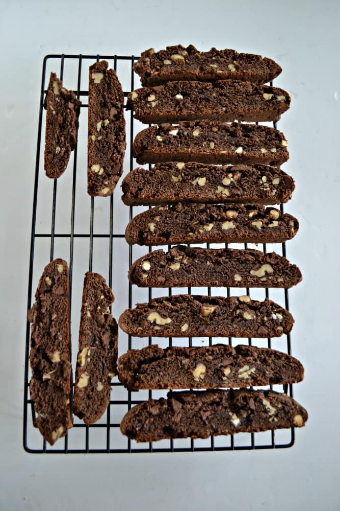 A cooling rack with chocolate biscotti laying on it.