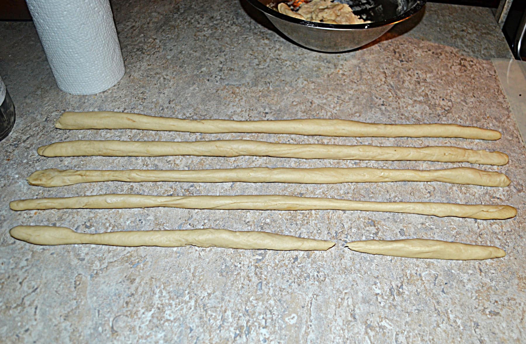 Five ropes of pretzel dough.