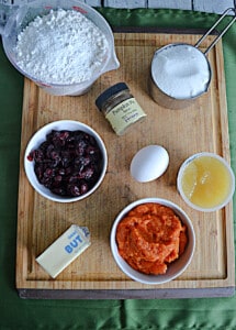 A cutting board with ingredients for making Pumpkin Muffins on it.