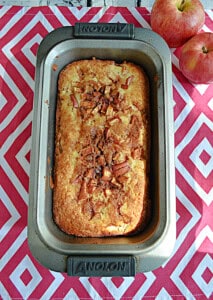 A loaf of bread with apples on top.