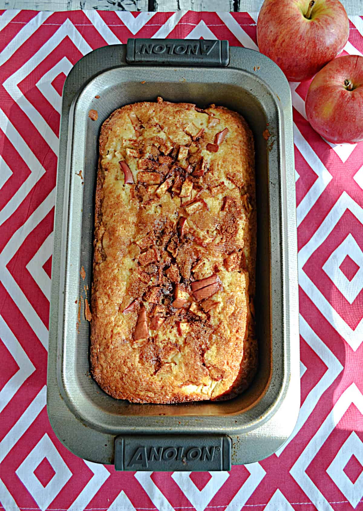 A loaf of bread with apples on top.