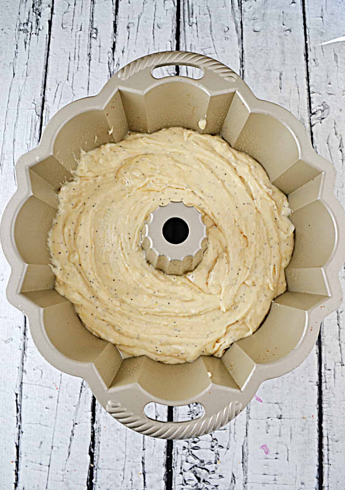 A Bundt pan with cake batter in it.