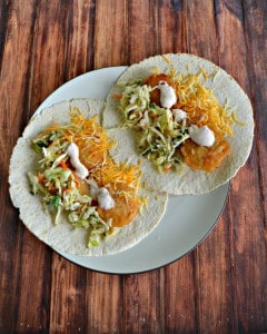 Enjoy these flavorful Beer Battered Fish Tacos topped with Lime Slaw, Salsa sour cream, and a sprinkle of cheese.