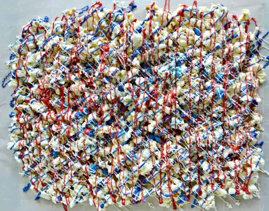 Popcorn drizzled with red, white, and blue chocolate and dotted with patriotic M&M's