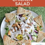Pin Image: Title, a plate of salad with chicken and dressing on top and pita triangles all around (No AI).