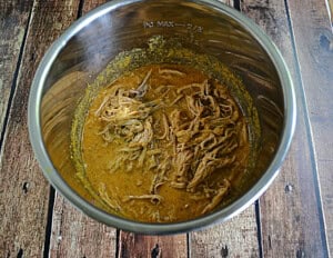 An Instant Pot filled with mustard barbecue pulled pork.