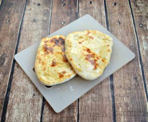 You don't need to be making Indian food to enjoy Naan! This flatbread only takes a few minutes to bake and it's delicious when brushed with garlic butter.