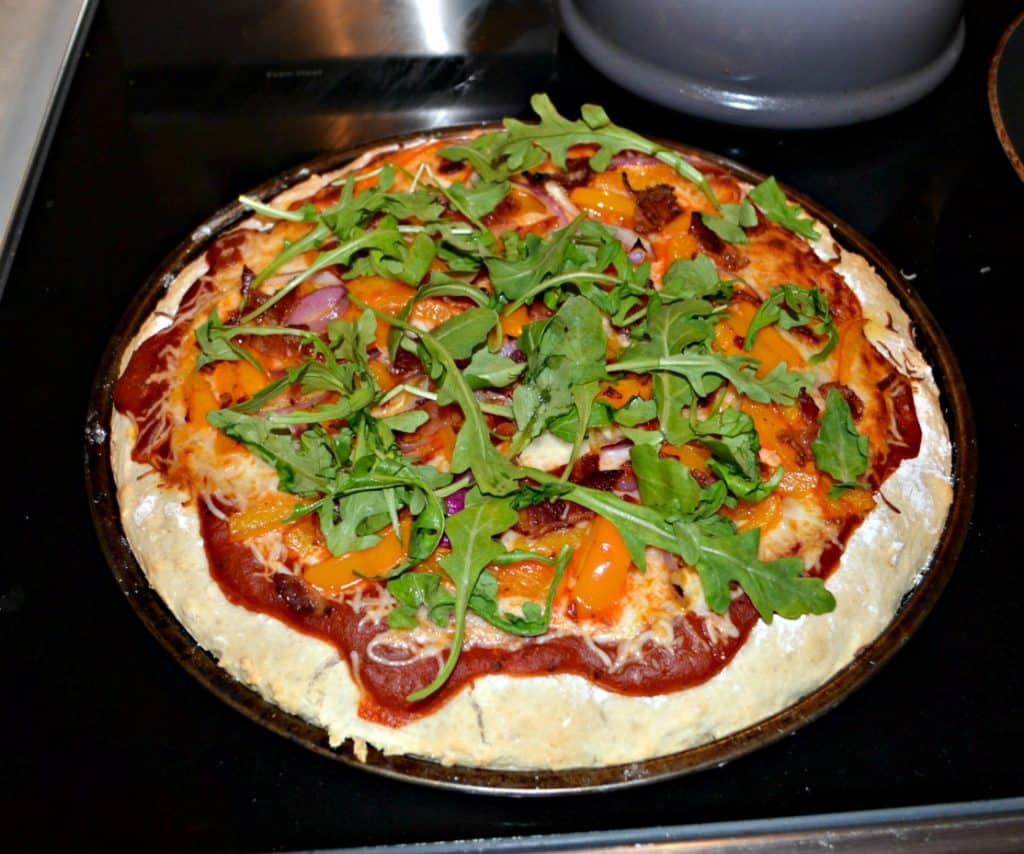 Enjoy a delicious gourmet pizza at home with Peppers, Bacon, Red Onions, and Arugula