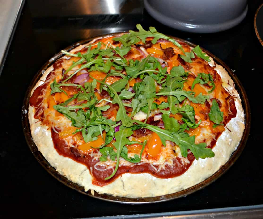 Pizza with Red Onion, Bacon, Peppers, and Arugula
