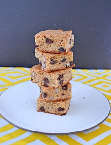 A plate with a tower of blondies on it.