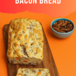 Pin Image: Title, a loaf of bread with a slice cut off and a bowl of pecans beside it.