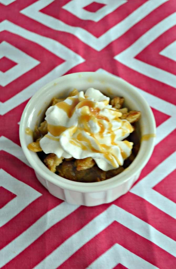 Caramel Apple Pecan Cobbler topped with whipped cream and caramel sauce