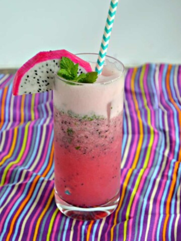 Looking for a twist on the classic mojito? This Dragon Fruit Pomegranate Mojito is super fun!