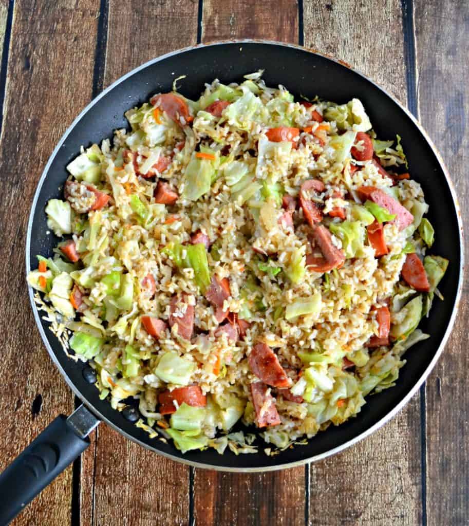 Budget Meal Alert! This heart Kielbasa and Cabbage Skilelt with Buttered Rice costs just $5, takes 20 minutes to make, and feeds a family of 4!