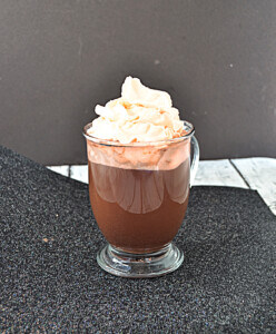 A mug of hot cocoa with whipped cream.