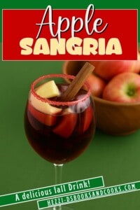 Pin Image: Title, a glass of sangria with apples and a cinnamon stick in it.