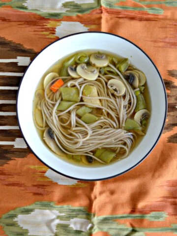 A bowl of chicken soup with soba noodles
