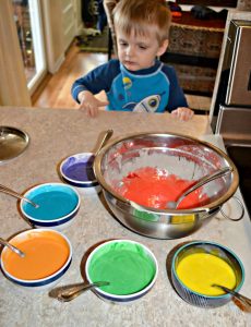 My toddler mixing up Tie Dye Cake